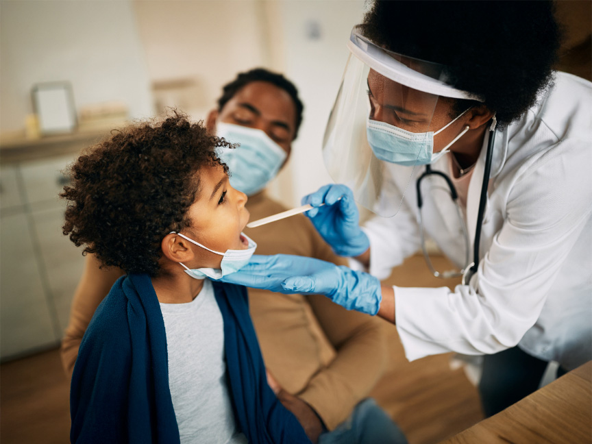 Master of Public Health doctor taking a child's temperature with an oral thermometer, highlighting care and health monitoring in the MPH program.